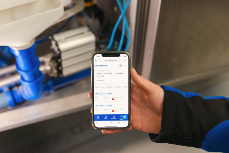Mobiele telefoon met DeLaval Plus app en data vanuit DeLaval Milk Solids Analysis